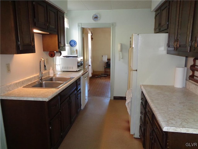 kitchen with sink, dark brown cabinets, and light wood-type flooring