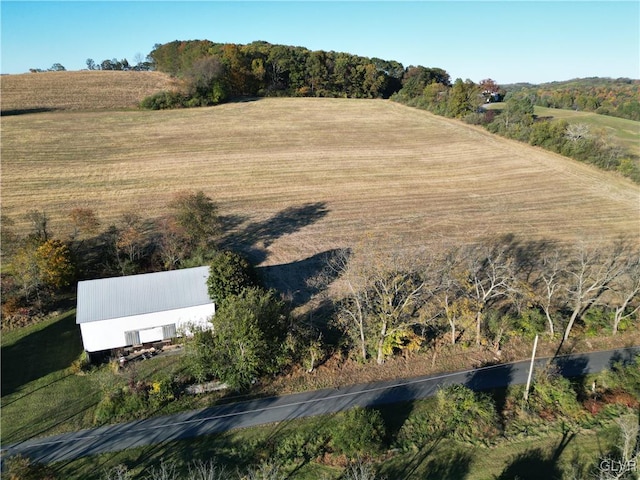 birds eye view of property with a rural view