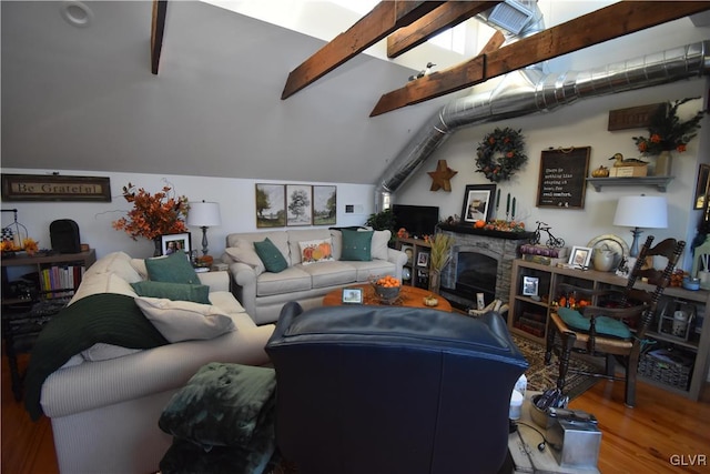 living room with a fireplace, vaulted ceiling with beams, and hardwood / wood-style flooring