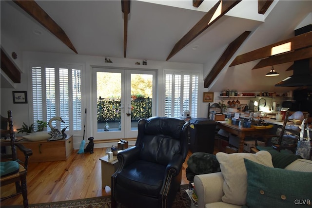 living room with french doors, lofted ceiling with beams, and light hardwood / wood-style flooring