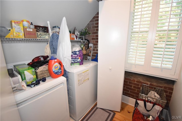 washroom with hardwood / wood-style flooring and separate washer and dryer