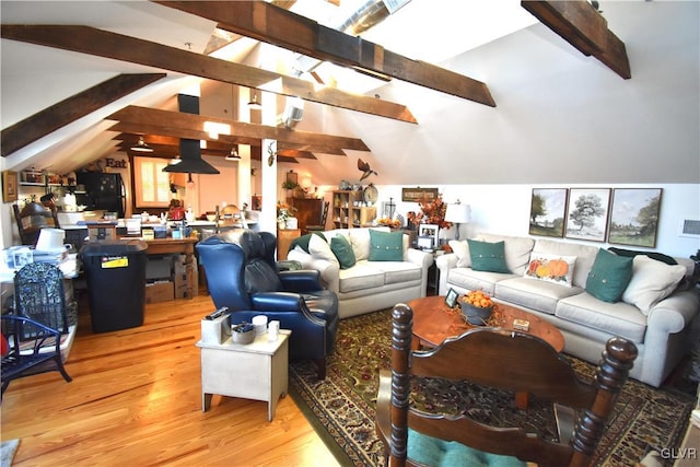 living room featuring light hardwood / wood-style flooring and lofted ceiling with beams