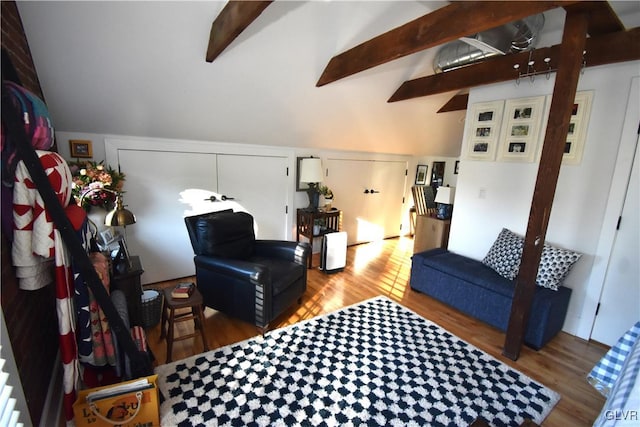 living room featuring lofted ceiling with beams and hardwood / wood-style floors