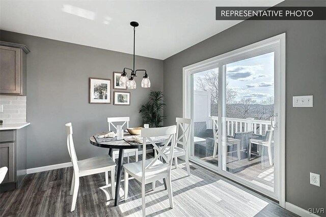 dining area featuring a chandelier and dark hardwood / wood-style floors