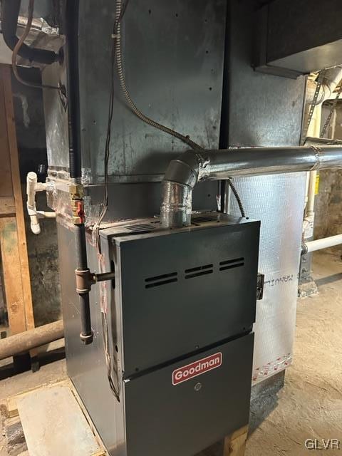 utility room featuring heating unit