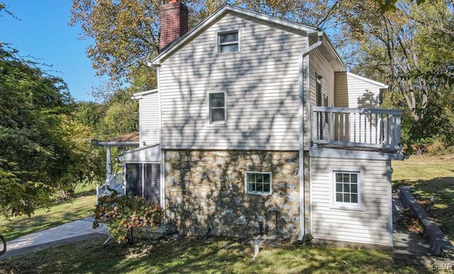 3331 Walnut St, Bethlehem Twp, PA 18020 - view of home's exterior with a chimney, a yard, and a balcony