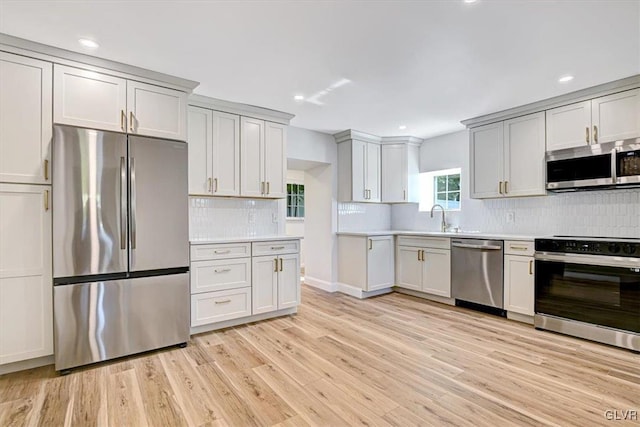 3331 Walnut St, Bethlehem Twp, PA 18020 - kitchen with appliances with stainless steel finishes, backsplash, light countertops, light wood-style flooring, and recessed lighting