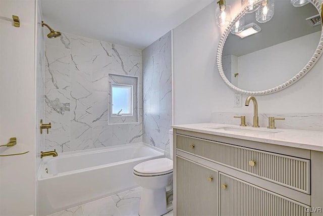 full bathroom featuring vanity, toilet, and tiled shower / bath