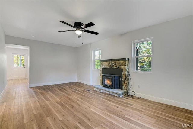 unfurnished living room featuring light hardwood / wood-style flooring and ceiling fan