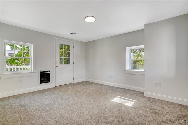 3331 Walnut St, Bethlehem Twp, PA 18020 - unfurnished living room featuring carpet flooring, healthy amount of natural light, baseboards, and heating unit