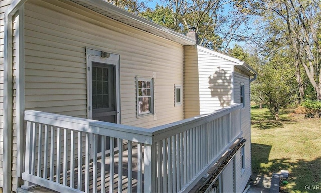 view of side of property featuring a yard and a deck