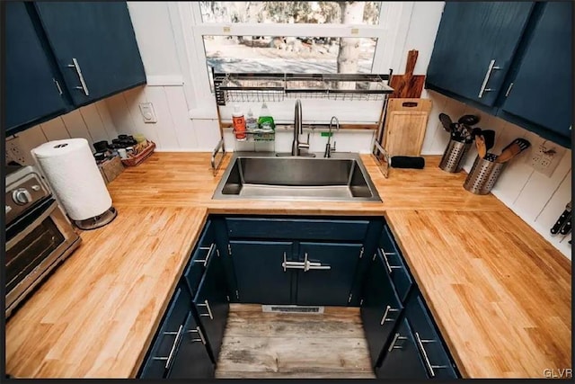 kitchen with blue cabinetry and sink