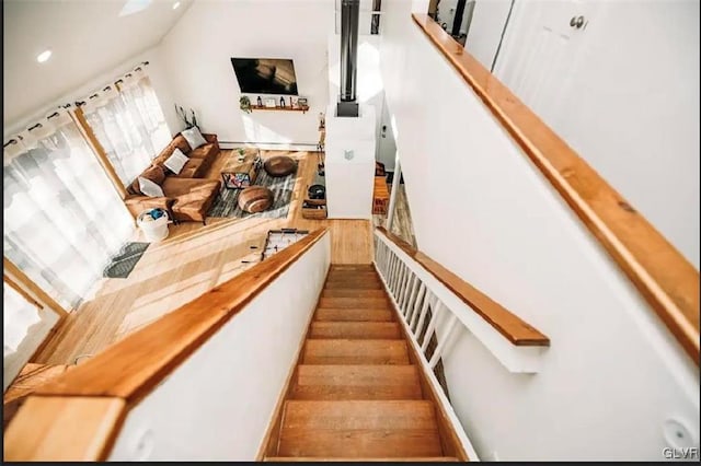 stairs featuring hardwood / wood-style floors