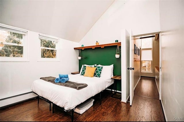 bedroom featuring lofted ceiling, dark hardwood / wood-style flooring, and baseboard heating