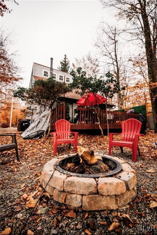 exterior space featuring a fire pit and a wooden deck