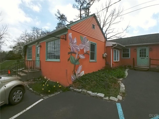 view of side of property featuring stucco siding