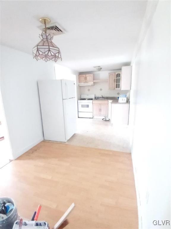 interior space featuring sink and light wood-type flooring