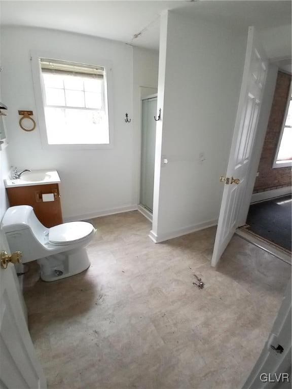 bathroom featuring vanity, toilet, and an enclosed shower