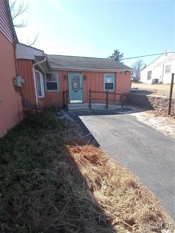 view of front of property featuring board and batten siding and a shingled roof