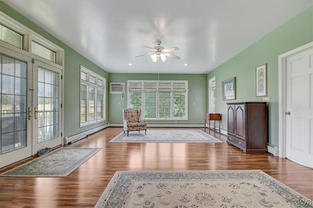 unfurnished room with french doors, a baseboard heating unit, hardwood / wood-style flooring, and ceiling fan