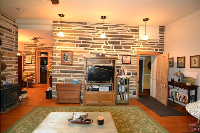 living room with hardwood / wood-style floors and a wood stove