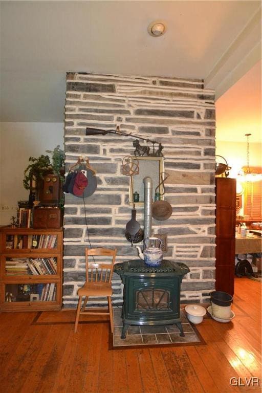 interior details with a wood stove and hardwood / wood-style floors