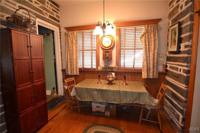 dining area featuring wood finished floors and a chandelier