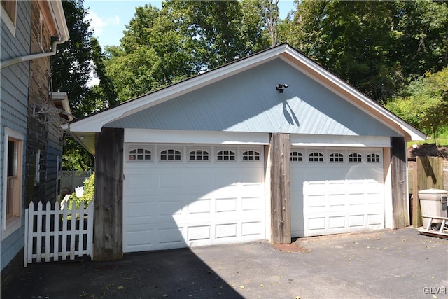 detached garage featuring fence