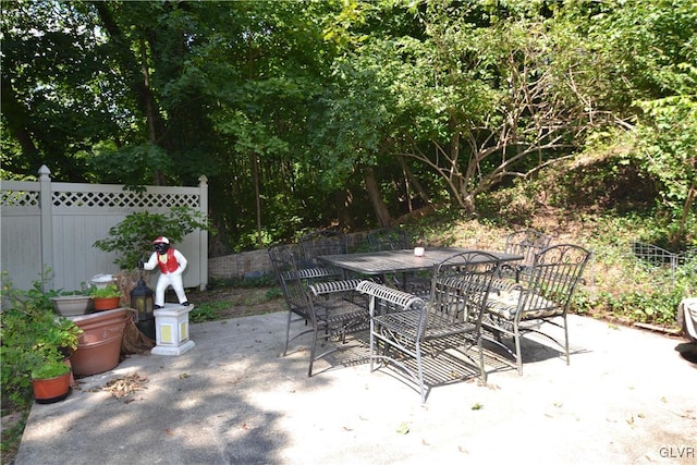 view of patio with outdoor dining area and fence