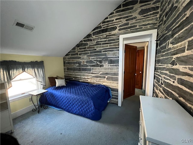 bedroom featuring vaulted ceiling, carpet, and visible vents