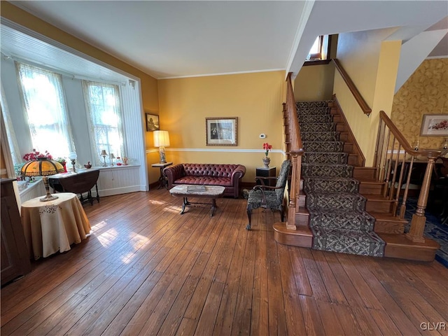 living area featuring stairway, baseboards, and wood-type flooring