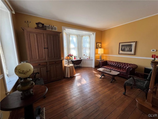 living area with baseboards, dark wood-style flooring, and ornamental molding