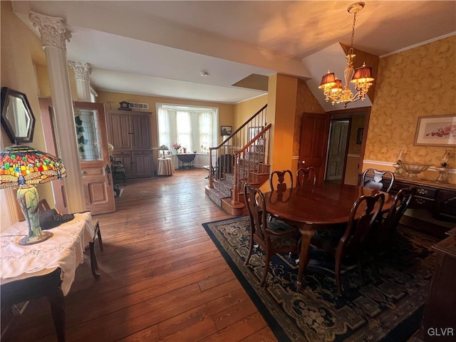 dining area featuring wallpapered walls, ornamental molding, stairs, hardwood / wood-style flooring, and a chandelier