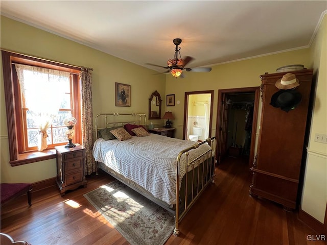 bedroom featuring ensuite bathroom, ceiling fan, and dark wood-style flooring