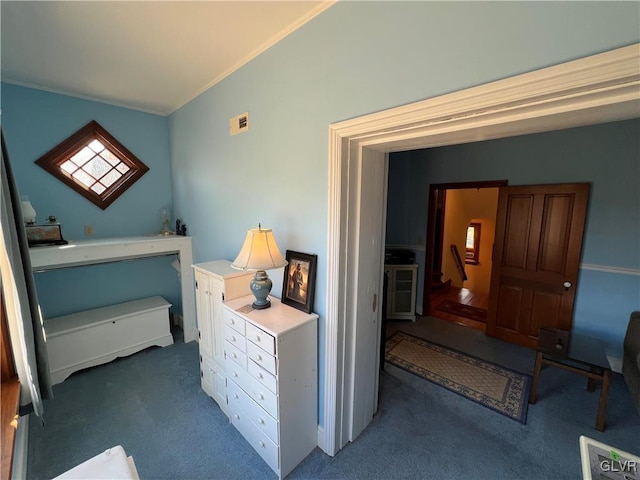 interior space featuring carpet flooring, visible vents, and ornamental molding