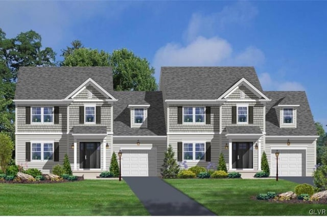 view of front of property with a front yard and a garage