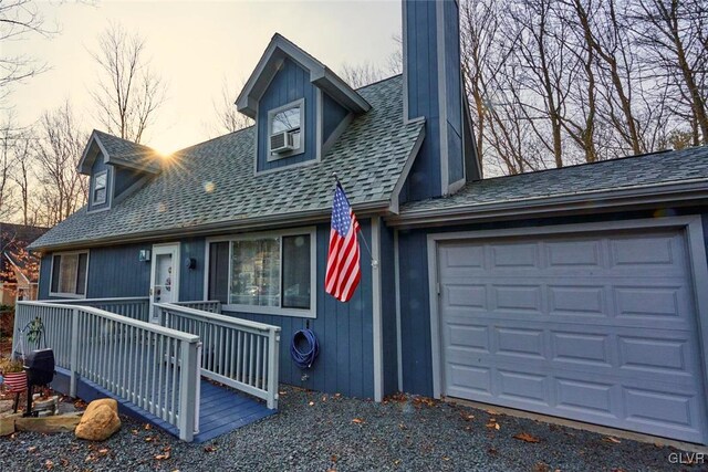 cape cod-style house featuring a garage