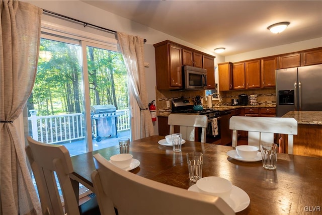 kitchen featuring hardwood / wood-style flooring, stainless steel appliances, tasteful backsplash, and sink