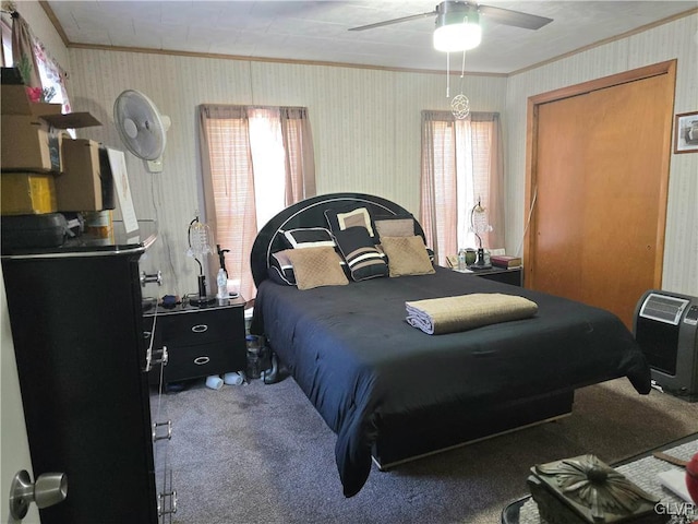 bedroom with carpet floors, ornamental molding, and ceiling fan