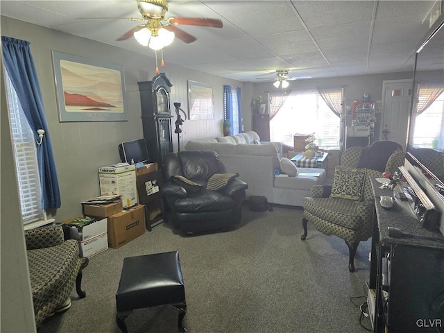 carpeted living room with a paneled ceiling and ceiling fan