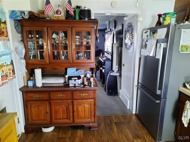 kitchen with stainless steel refrigerator and dark hardwood / wood-style flooring