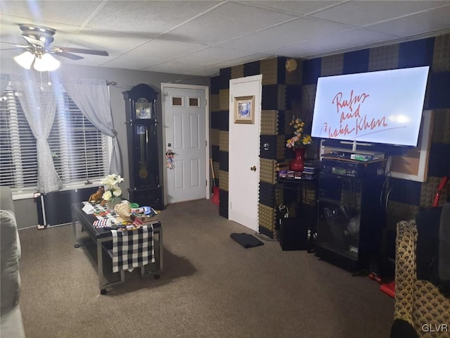 carpeted living room with a paneled ceiling and ceiling fan