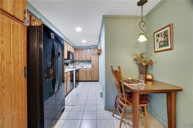 137 Outer Dr, Coolbaugh Twp, PA 18347 - kitchen with black appliances, light tile patterned flooring, light countertops, brown cabinetry, and recessed lighting