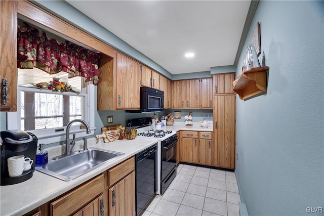 137 Outer Dr, Coolbaugh Twp, PA 18347 - kitchen with black appliances, light countertops, light tile patterned flooring, and brown cabinetry
