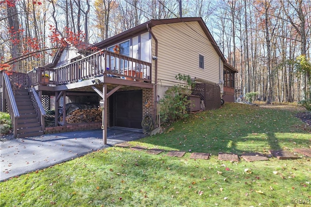 137 Outer Dr, Coolbaugh Twp, PA 18347 - view of side of property featuring a wooden deck, a lawn, asphalt driveway, brick siding, and stairway