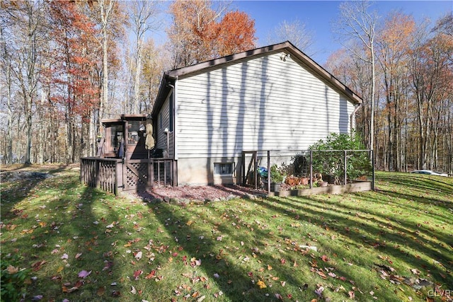 137 Outer Dr, Coolbaugh Twp, PA 18347 - view of home's exterior with a lawn, a vegetable garden, and a wooden deck