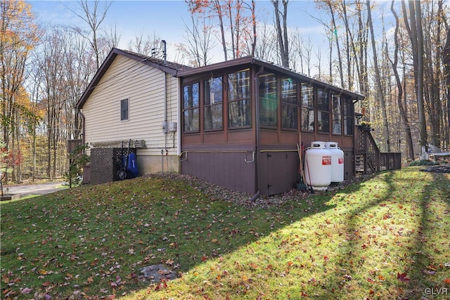 137 Outer Dr, Coolbaugh Twp, PA 18347 - view of side of property featuring a sunroom, a lawn, and stairs