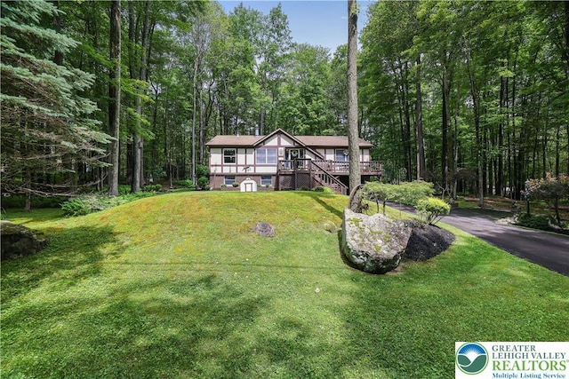 137 Outer Dr, Coolbaugh Twp, PA 18347 - view of front of property featuring a deck, a front yard, and a view of trees