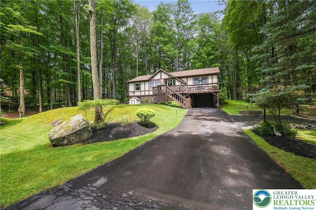 137 Outer Dr, Coolbaugh Twp, PA 18347 - tudor-style house with asphalt driveway, a garage, a deck, and a front yard