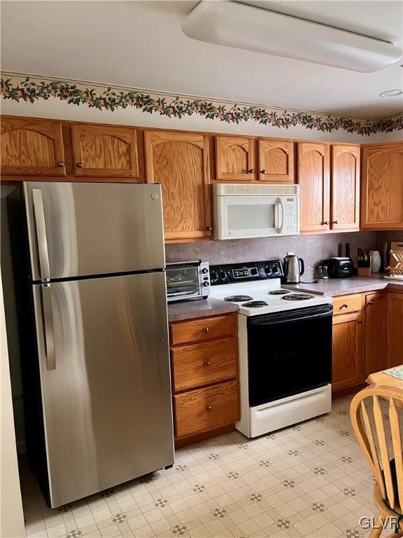 kitchen featuring white appliances and decorative backsplash